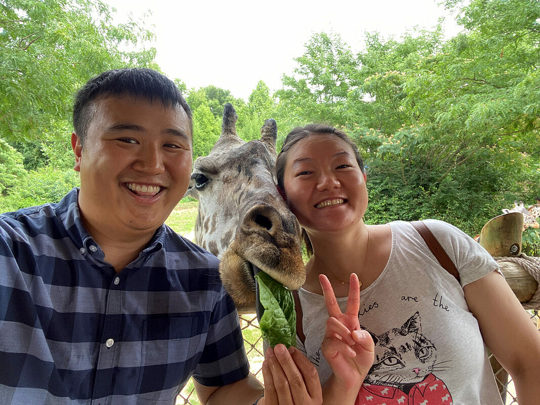 John and Lily at Cincinnati Zoo and Botanical Garden feeding giraffe.